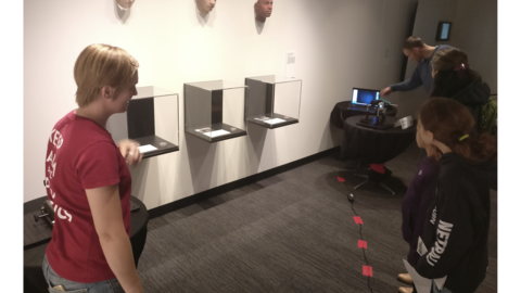 Applied Physics graduate student Emily presents Schlieren imaging to a family