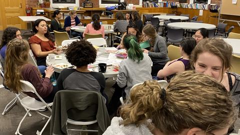Women in Physics members enjoying snacks and doing crafts.