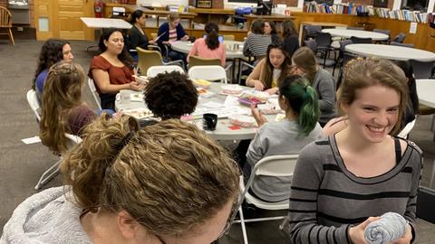 Women in Physics members enjoying snacks and doing crafts.