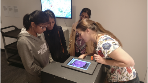 Previous postdoc Susannah presents ferrofluids to a group of women