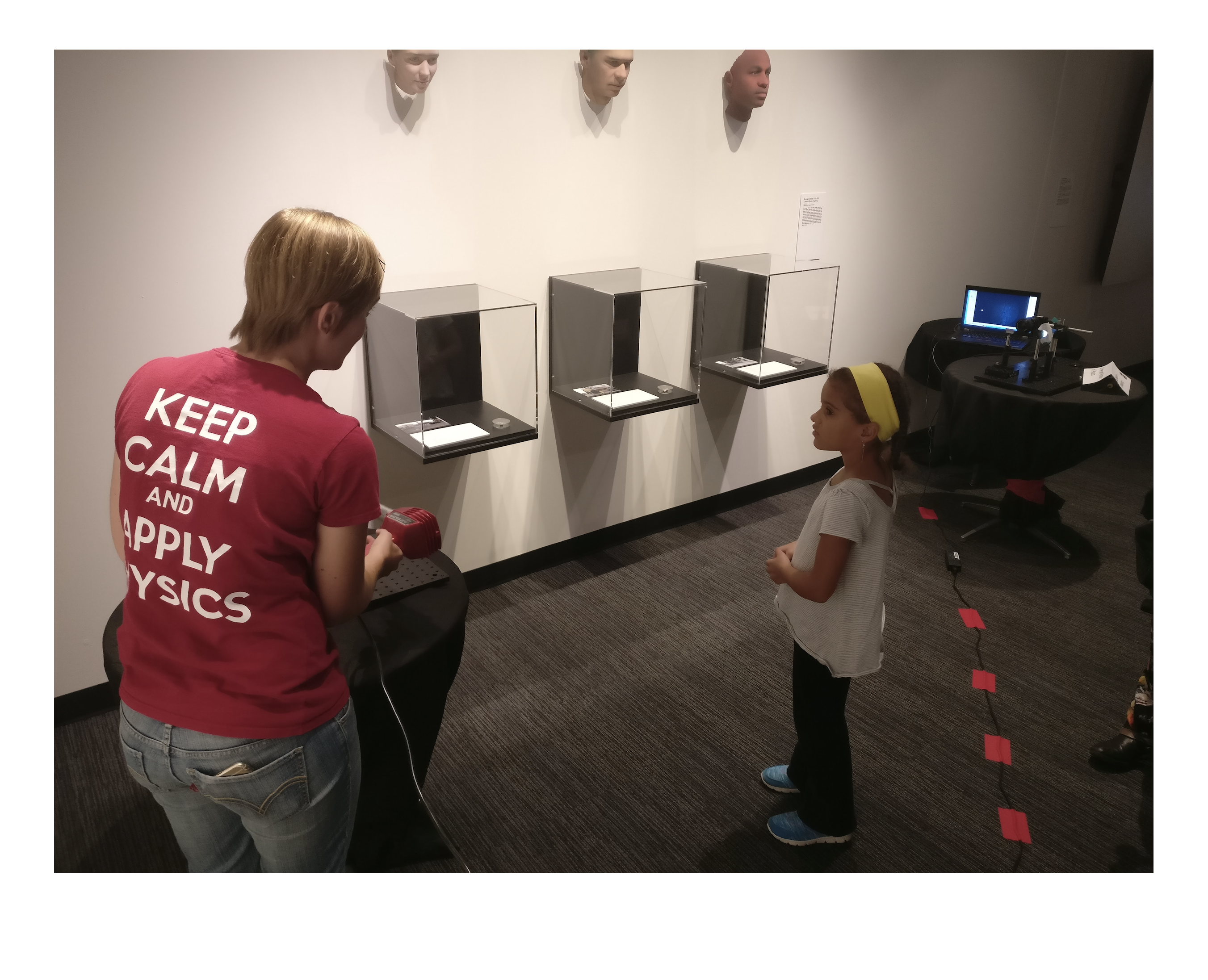 Applied Physics graduate student Emily presents Schlieren imaging to a young girl