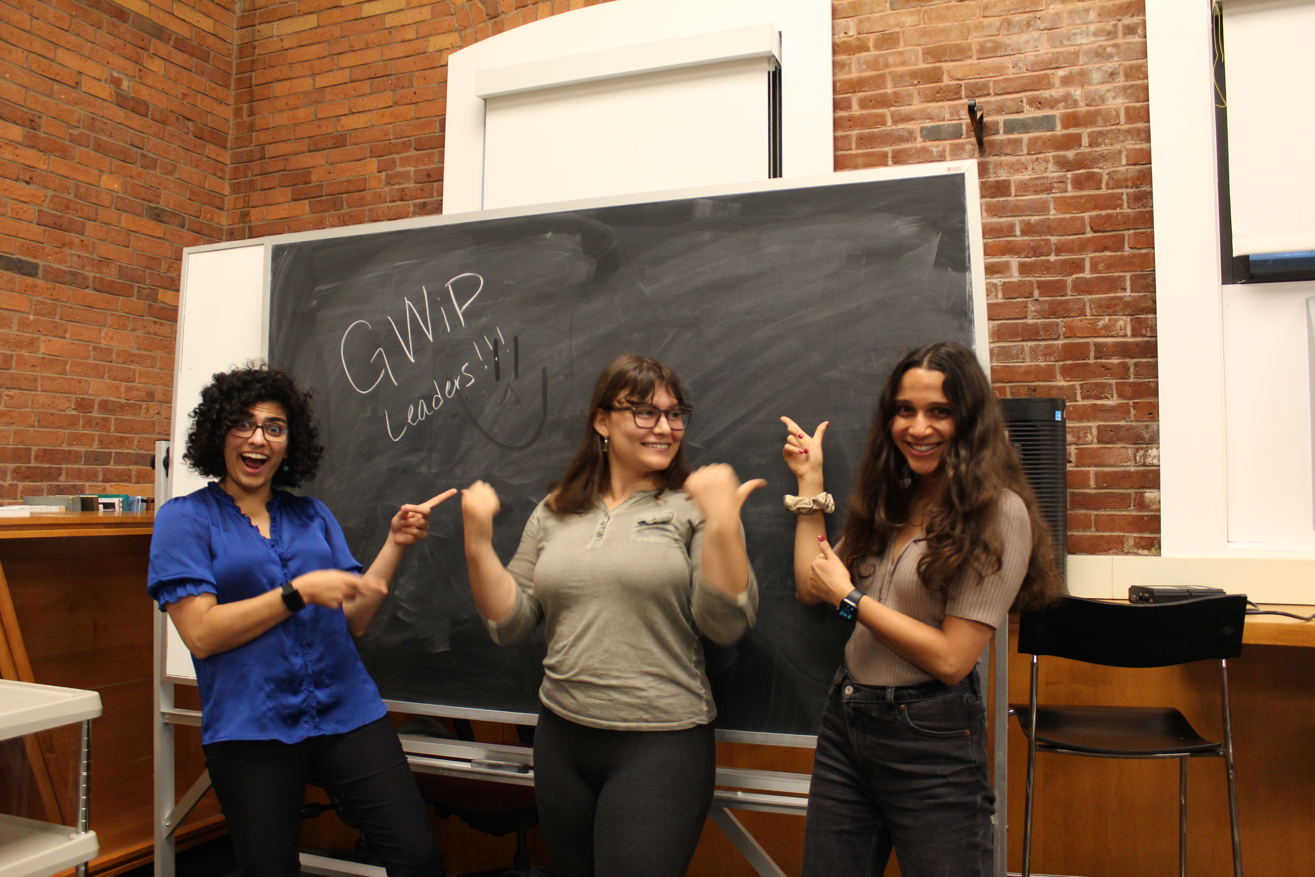 Image of GWiP Co-chairs in front of blackboard that says "GWiP ladies" (From left to right Hengameh Bagherian, Lara Braverman, Chandrika Chandrashekar)